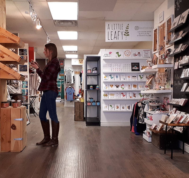 Woman browsing gifts in a cozy boutique store
